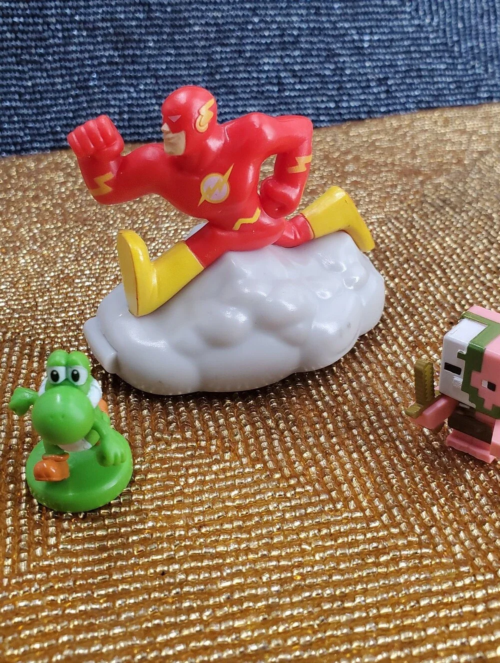 Mix of 9  small toy figures, miniature vehicles, and character charms. (C40)